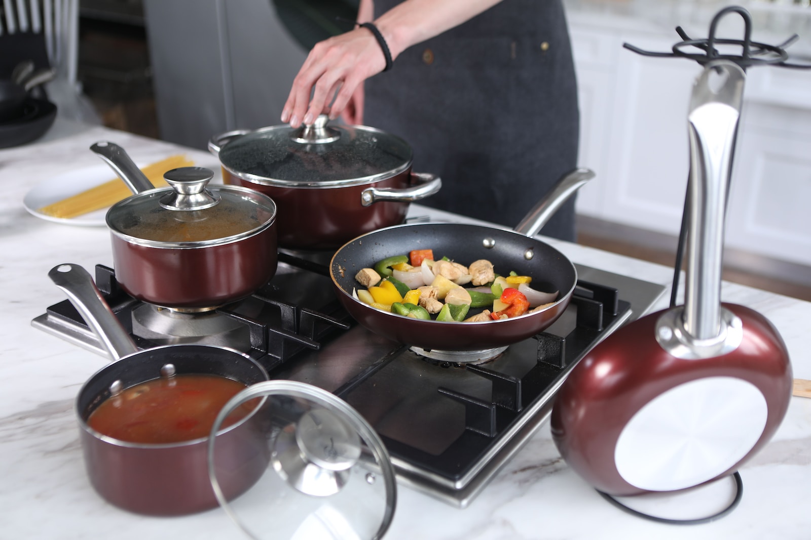 person cooking on stainless steel cooking pot