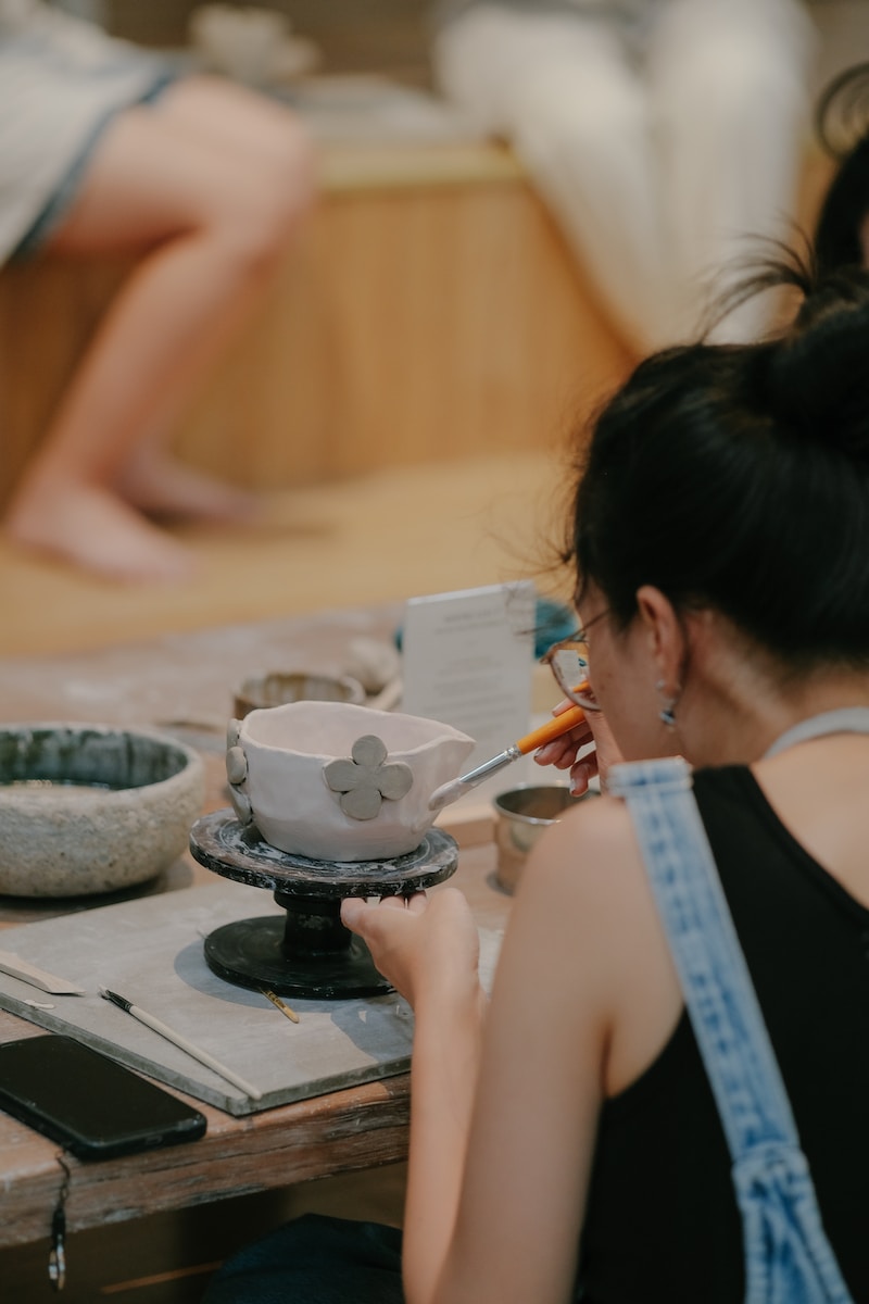 a woman sitting at a table with a bowl of food